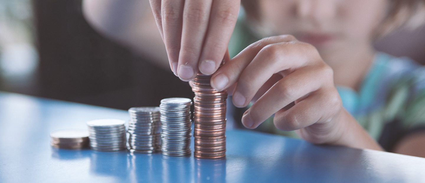 Photo of child stacking coins
