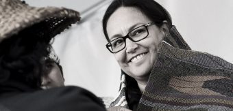 rst nation woman smiling at Act of reconcilation
