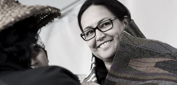 rst nation woman smiling at Act of reconcilation