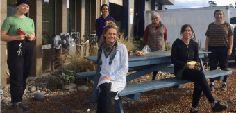 SIFarmHub team sit outside their warehouse