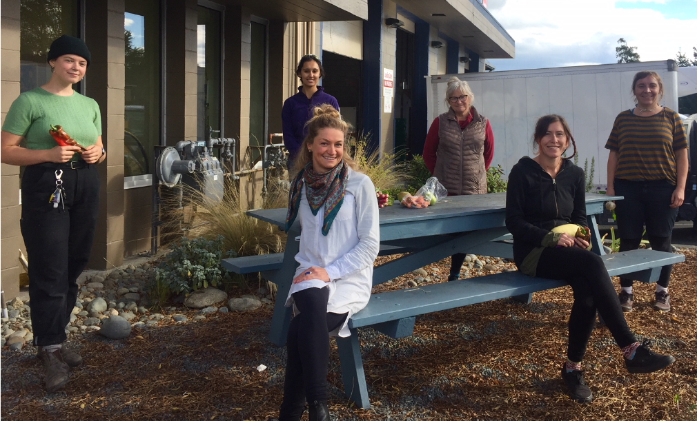 SIFarmHub team sit outside their warehouse